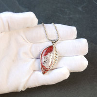 Crazy Lace agate pendant in hand
