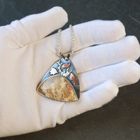 Regency Rose plume agate pendant in hand