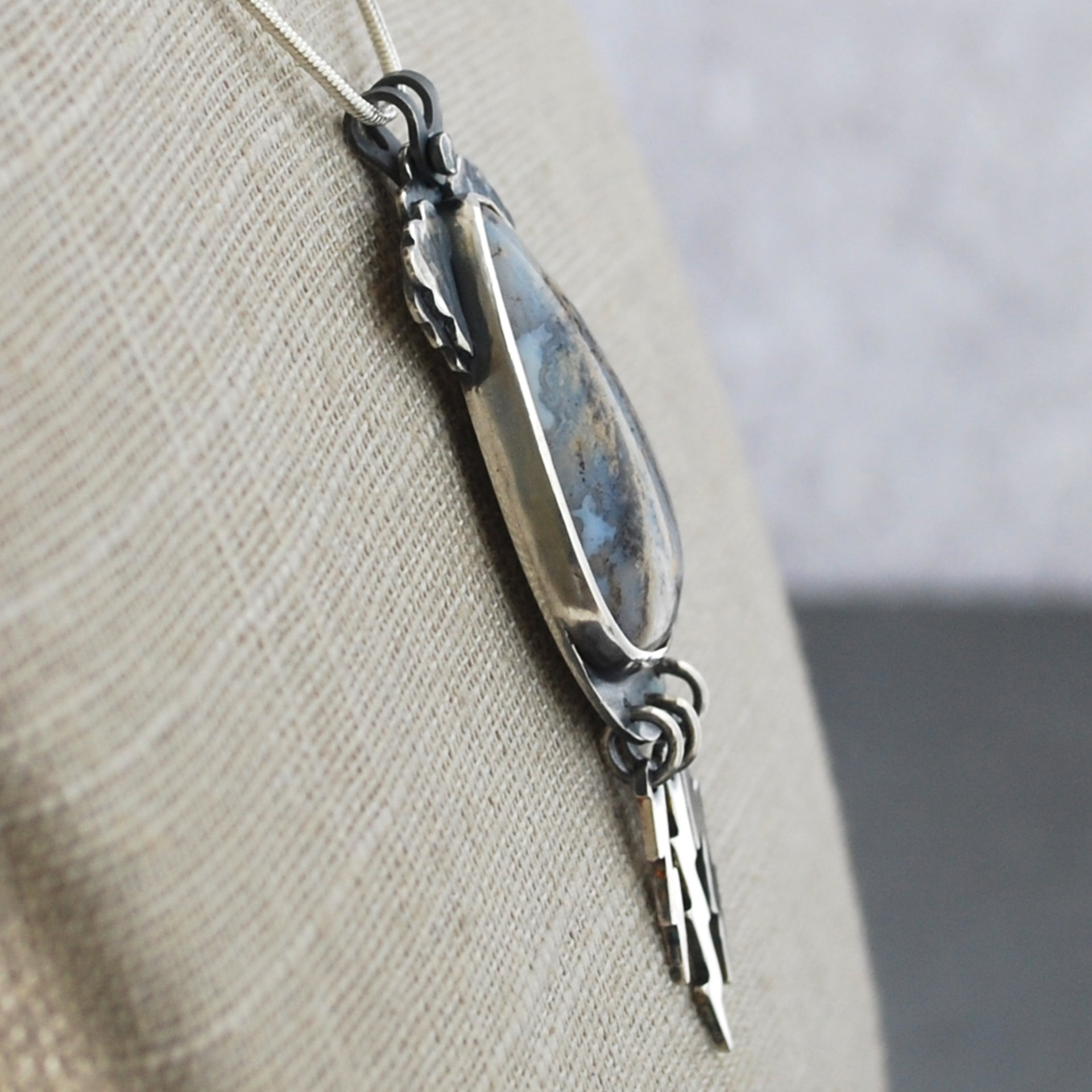 Graveyard Point Plume Agate Pendant with Lightning Bolts, angle