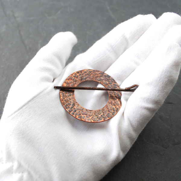 Rustic Hammered Copper Shawl Pin on scarf in hand