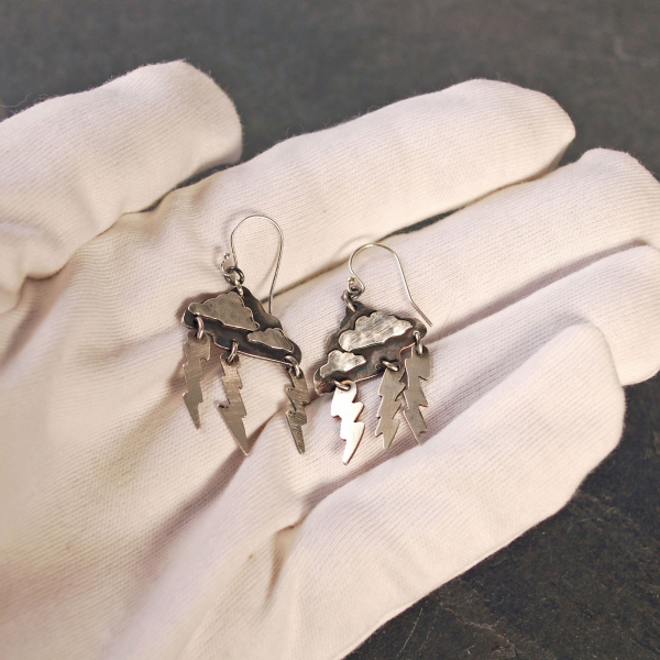 Silver Cloud Earrings with Lightning Bolts, in hand