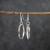 Silver Hoop Earrings hanging as worn