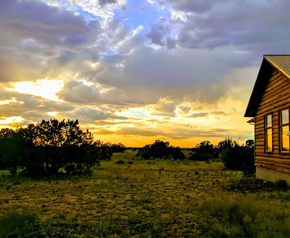 Cabin with sun setting behind