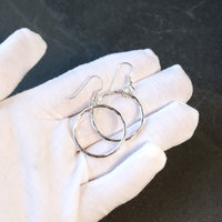 Silver Hoop Earrings in hand