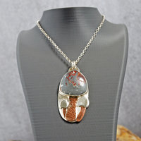 Silver pendant with rhyolite "mushroom cap, copper mushroom stem, two additional silver and copper mushrooms, hanging