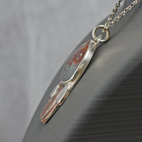 Silver pendant with rhyolite "mushroom cap, copper mushroom stem, two additional silver and copper mushrooms, close up angle