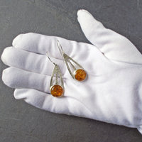 Baltic Amber Silver Drop Earrings in hand