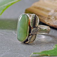 Nephrite Jade silver ring, with silver leaves beside stone on the top