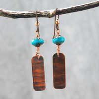 Earrings with corrugated copper rectangle dangles and turquoise Czech glass bead on top, hanging