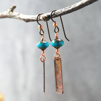 Earrings with corrugated copper rectangle dangles and turquoise Czech glass bead on top, hanging
