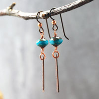 Earrings with corrugated copper rectangle dangles and turquoise Czech glass bead on top, hanging