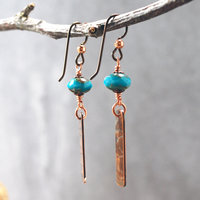 Earrings with corrugated copper rectangle dangles and turquoise Czech glass bead on top, hanging