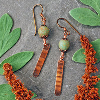 Earrings with green matte Czech glass on top, textured copper dangle below