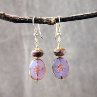 Pale purple Czech glass earrings, swallow embossed flat beads at bottom, topped by faceted rondelle beads, hanging