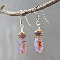 Pale purple Czech glass earrings, swallow embossed flat beads at bottom, topped by faceted rondelle beads, hanging