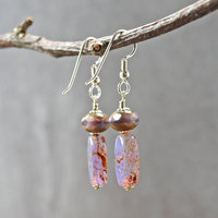 Pale purple Czech glass earrings, swallow embossed flat beads at bottom, topped by faceted rondelle beads, hanging