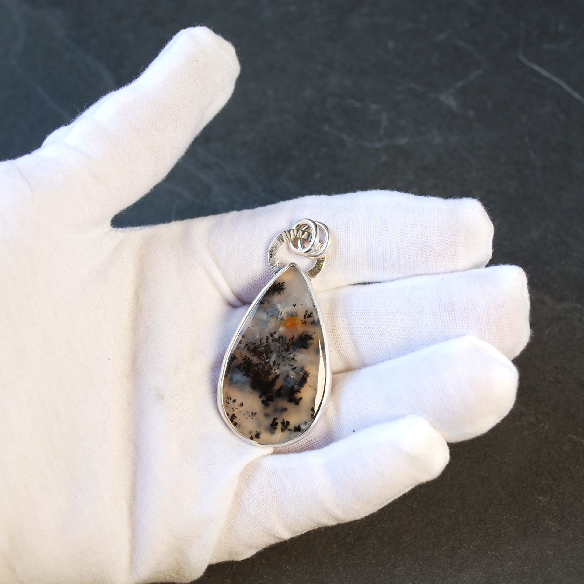 Marfa Plume Agate Pendant in hand