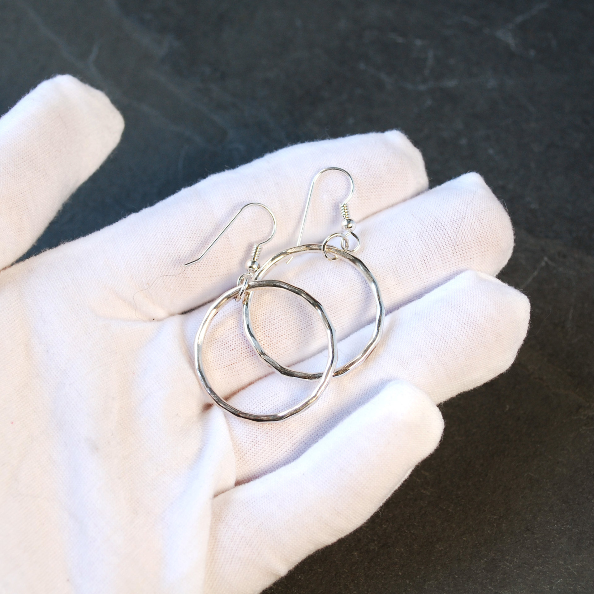 Silver Hoop Earrings in hand