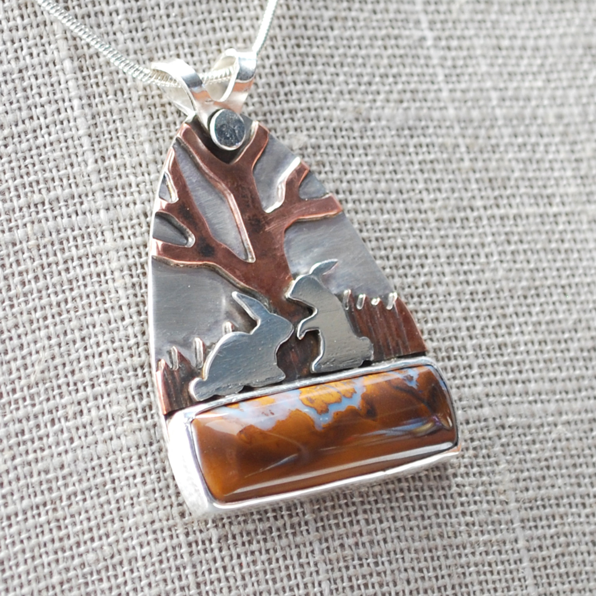 Boulder Opal Pendant with Rabbits, Tree closeup angle