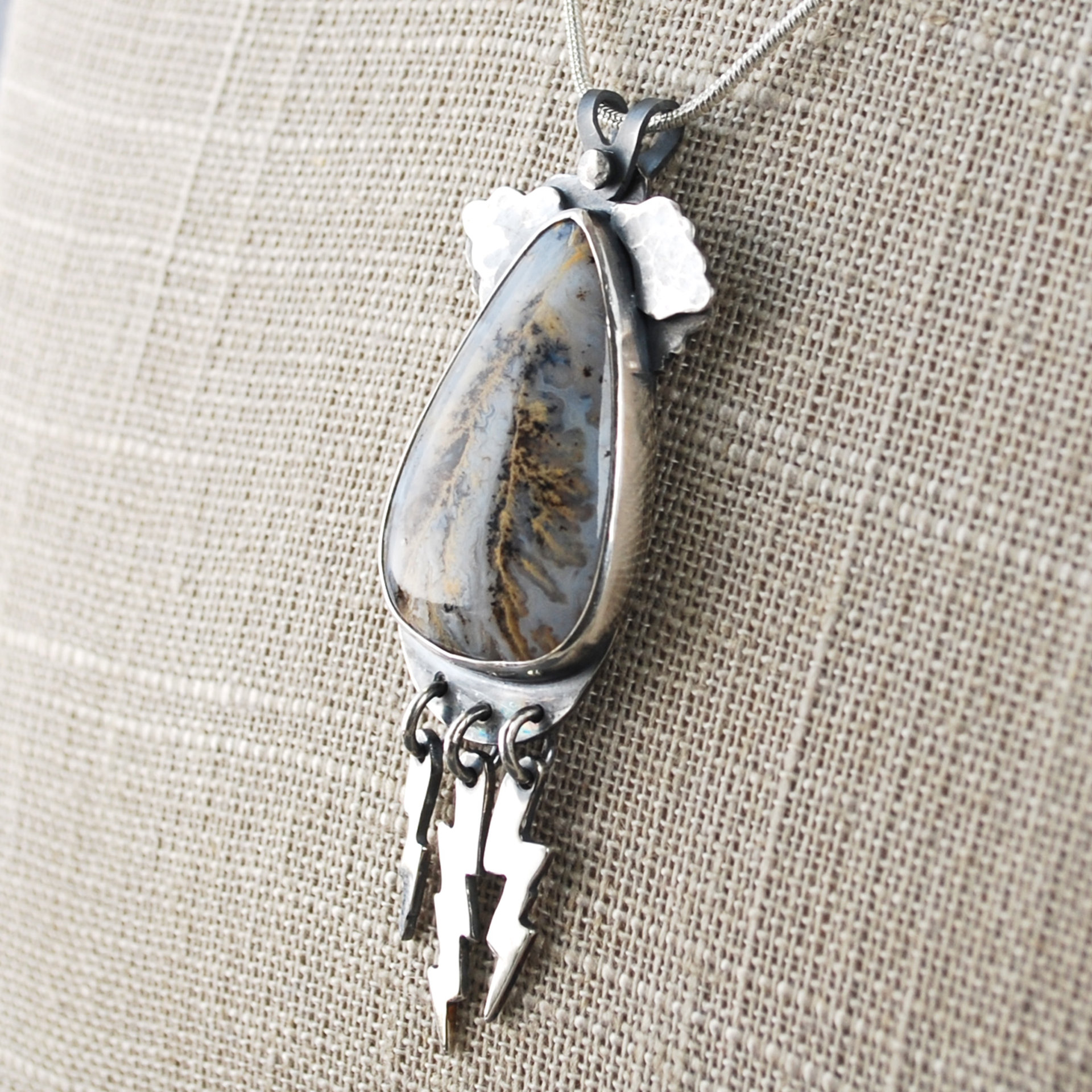 Graveyard Point Plume Agate Pendant with Lightning Bolts, angle