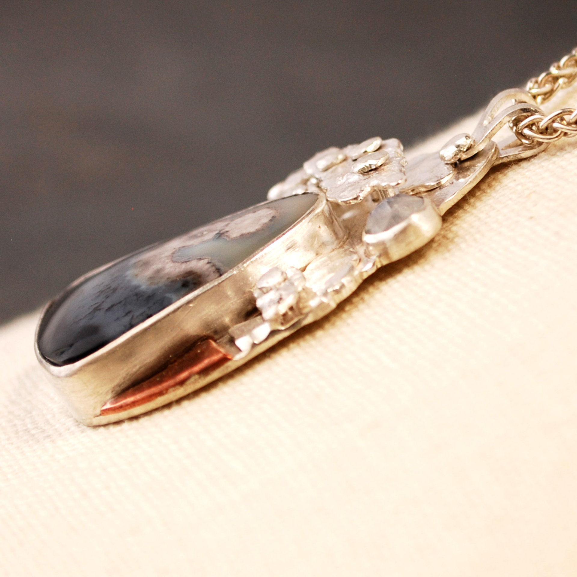 Silver Agate Pendant, Riveted Clouds closeup angle