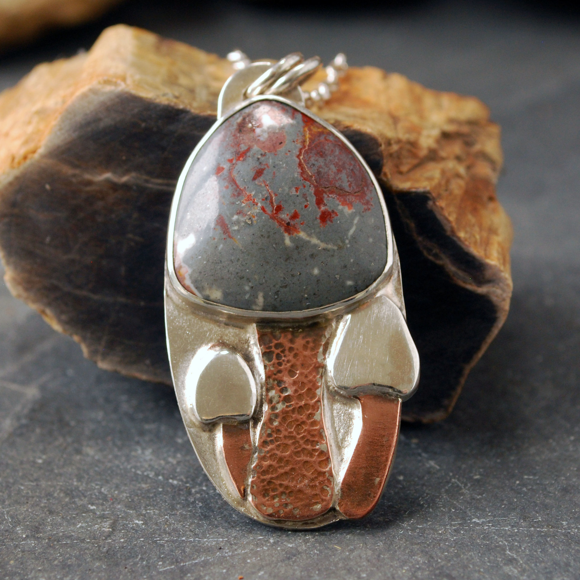 Silver pendant with rhyolite "mushroom cap, copper mushroom stem, two additional silver and copper mushrooms