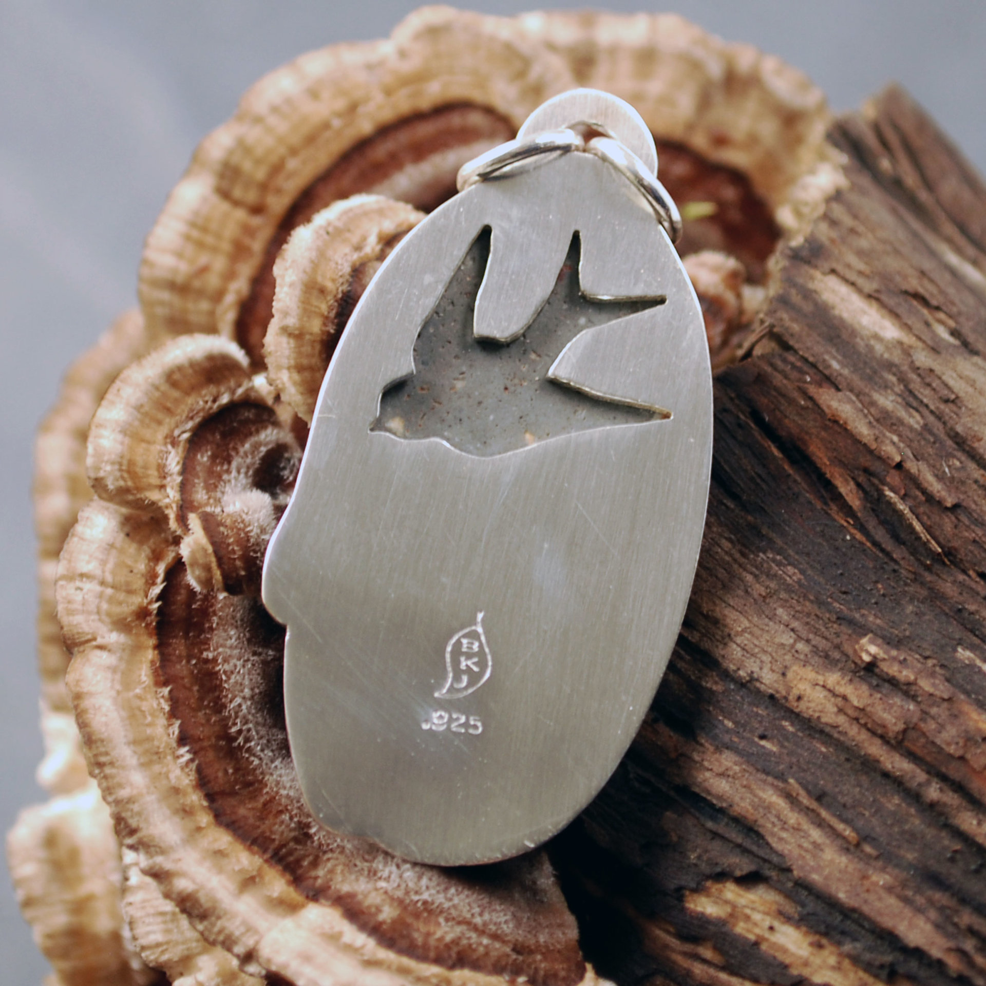 Silver pendant with rhyolite "mushroom cap, swallow cut out behind stone
