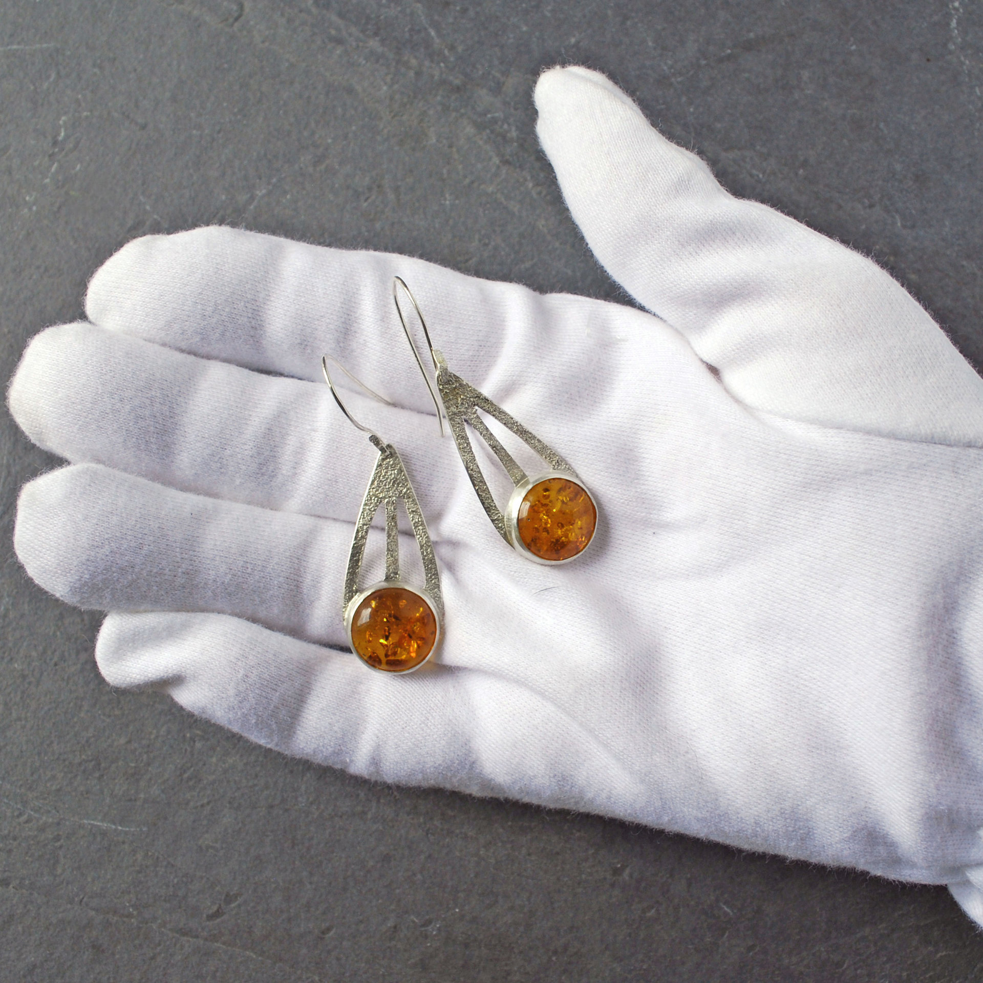 Baltic Amber Silver Drop Earrings in hand