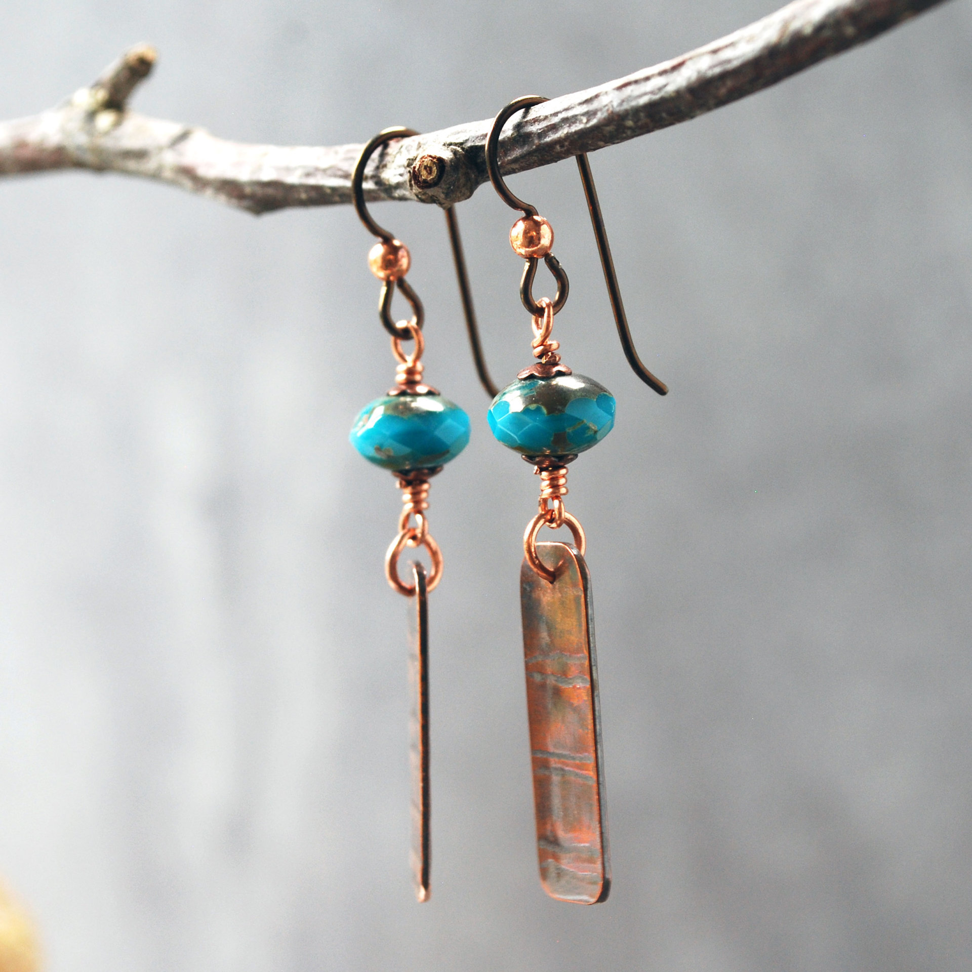 Earrings with corrugated copper rectangle dangles and turquoise Czech glass bead on top, hanging