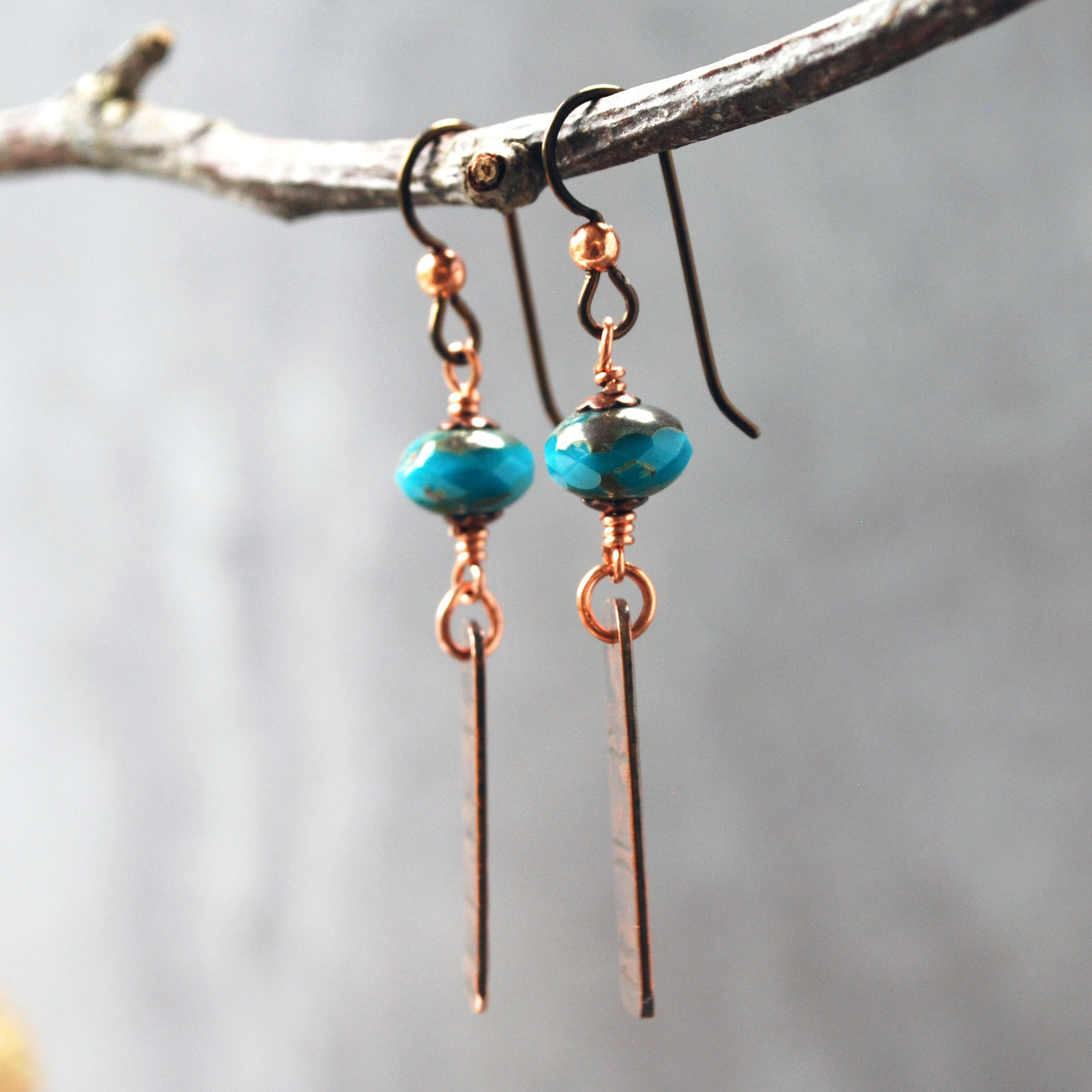 Earrings with corrugated copper rectangle dangles and turquoise Czech glass bead on top, hanging