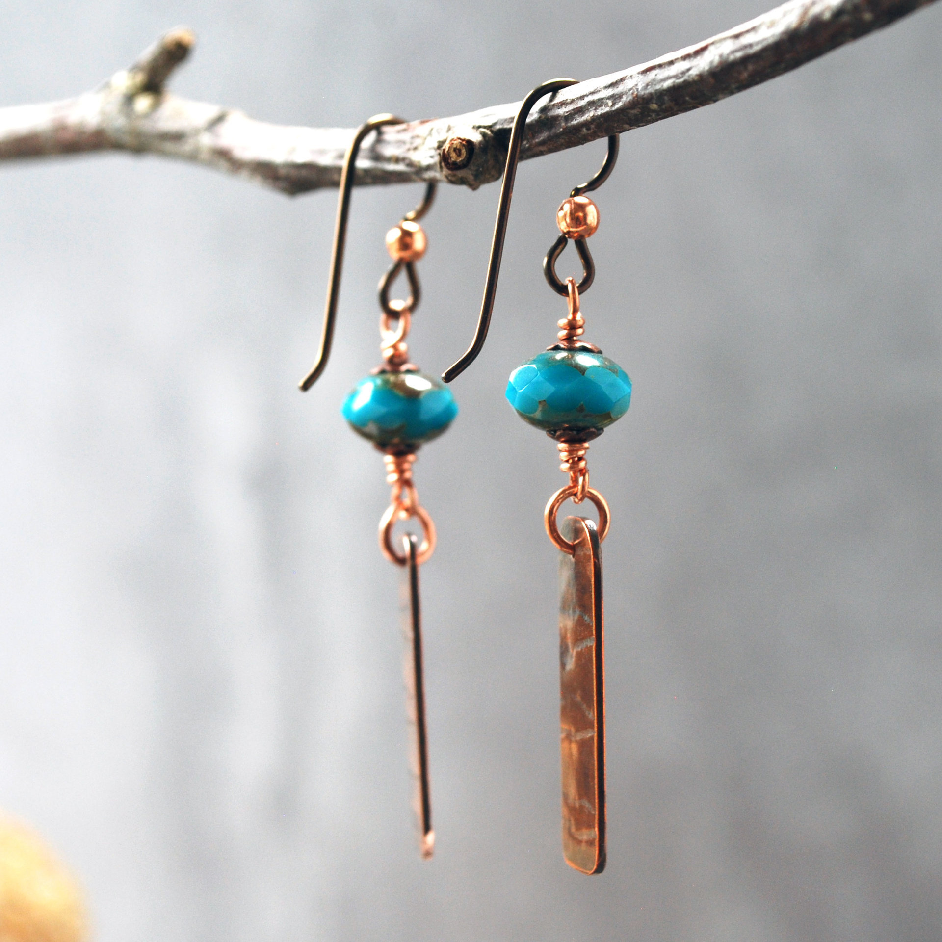 Earrings with corrugated copper rectangle dangles and turquoise Czech glass bead on top, hanging