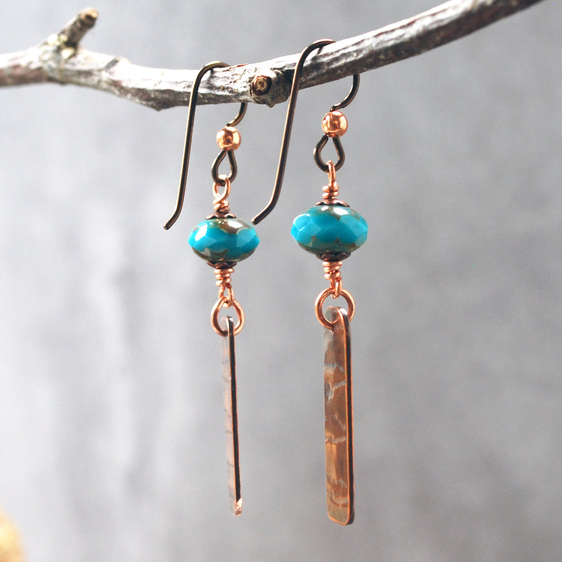 Earrings with corrugated copper rectangle dangles and turquoise Czech glass bead on top, hanging