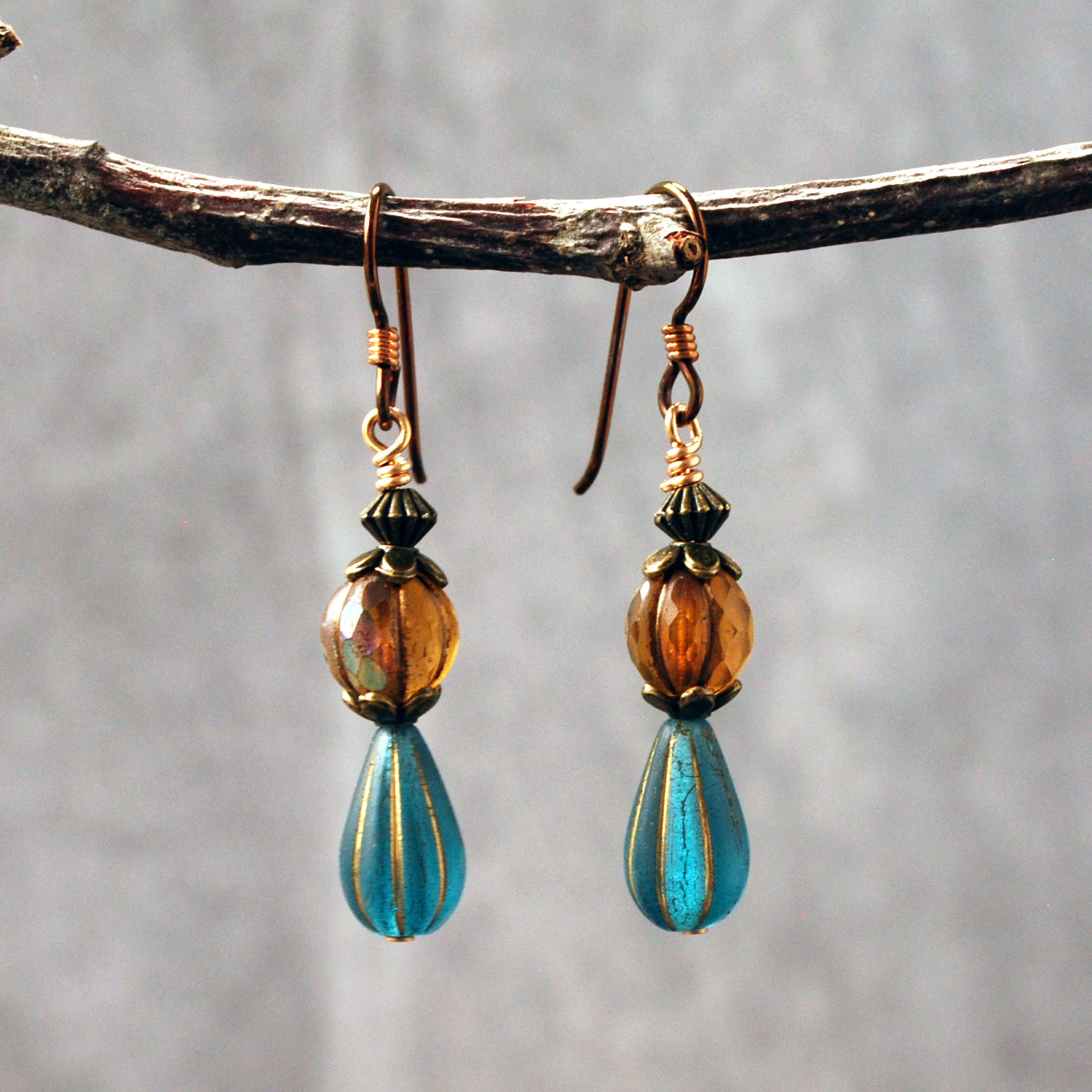 Dangling earrings with Czech Glass amber and blue beads hanging