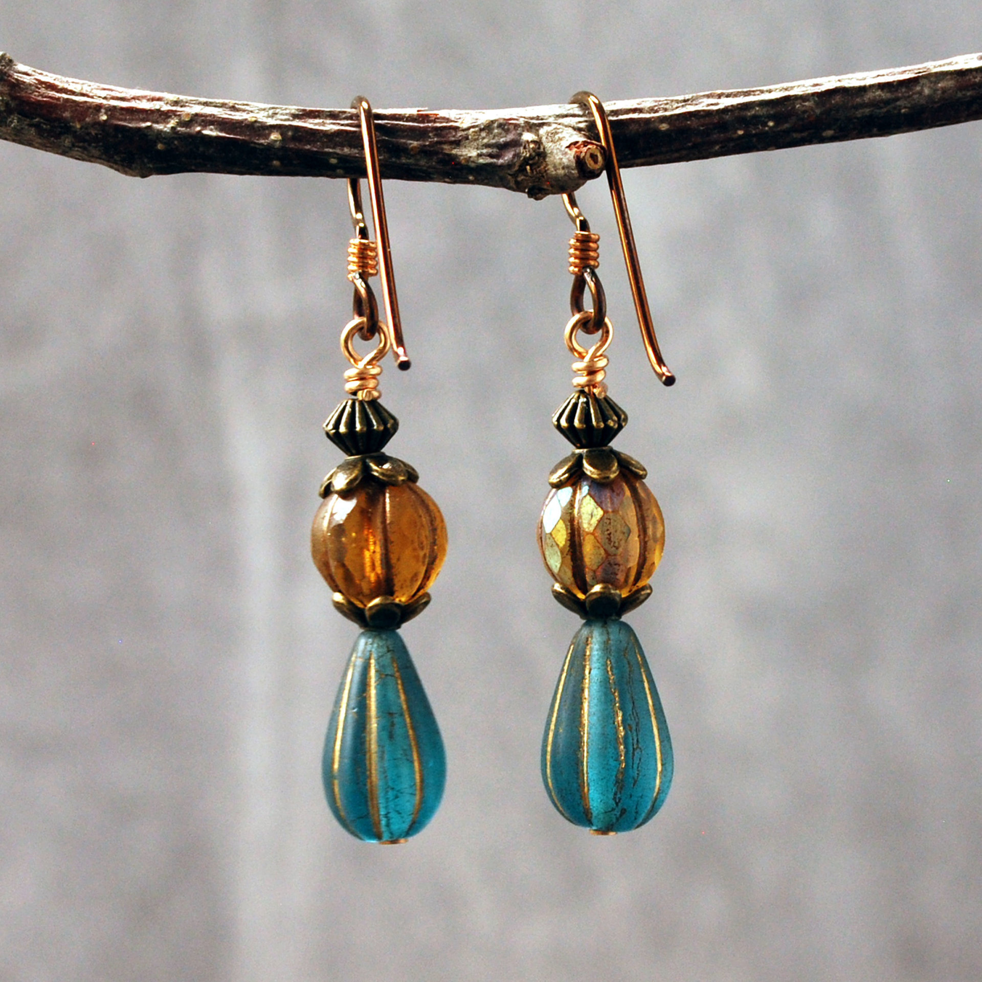 Dangling earrings with Czech Glass amber and blue beads hanging