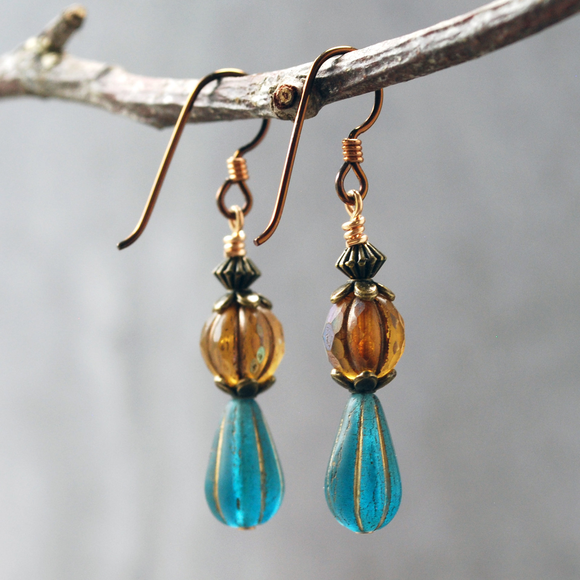 Dangling earrings with Czech Glass amber and blue beads hanging