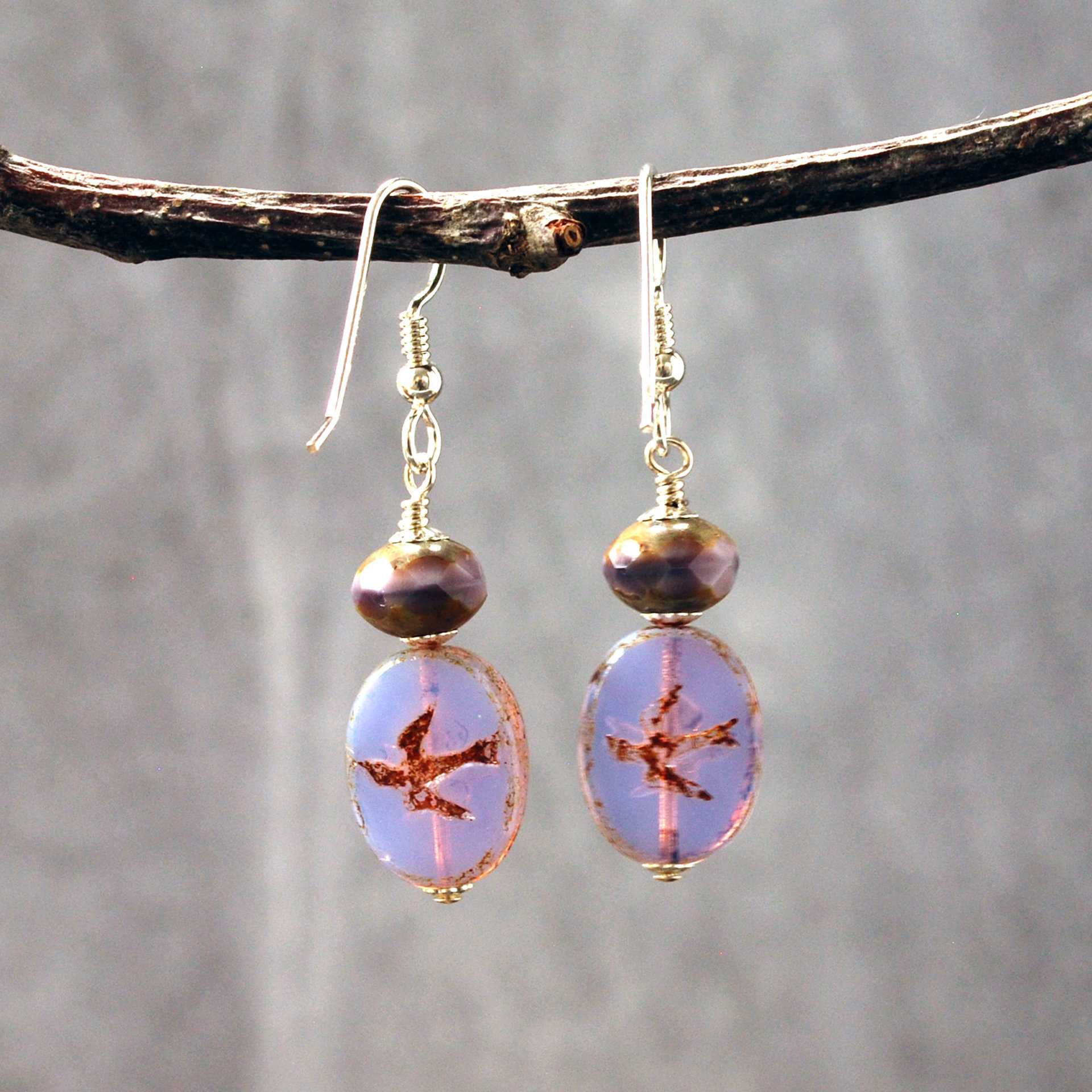 Pale purple Czech glass earrings, swallow embossed flat beads at bottom, topped by faceted rondelle beads, hanging