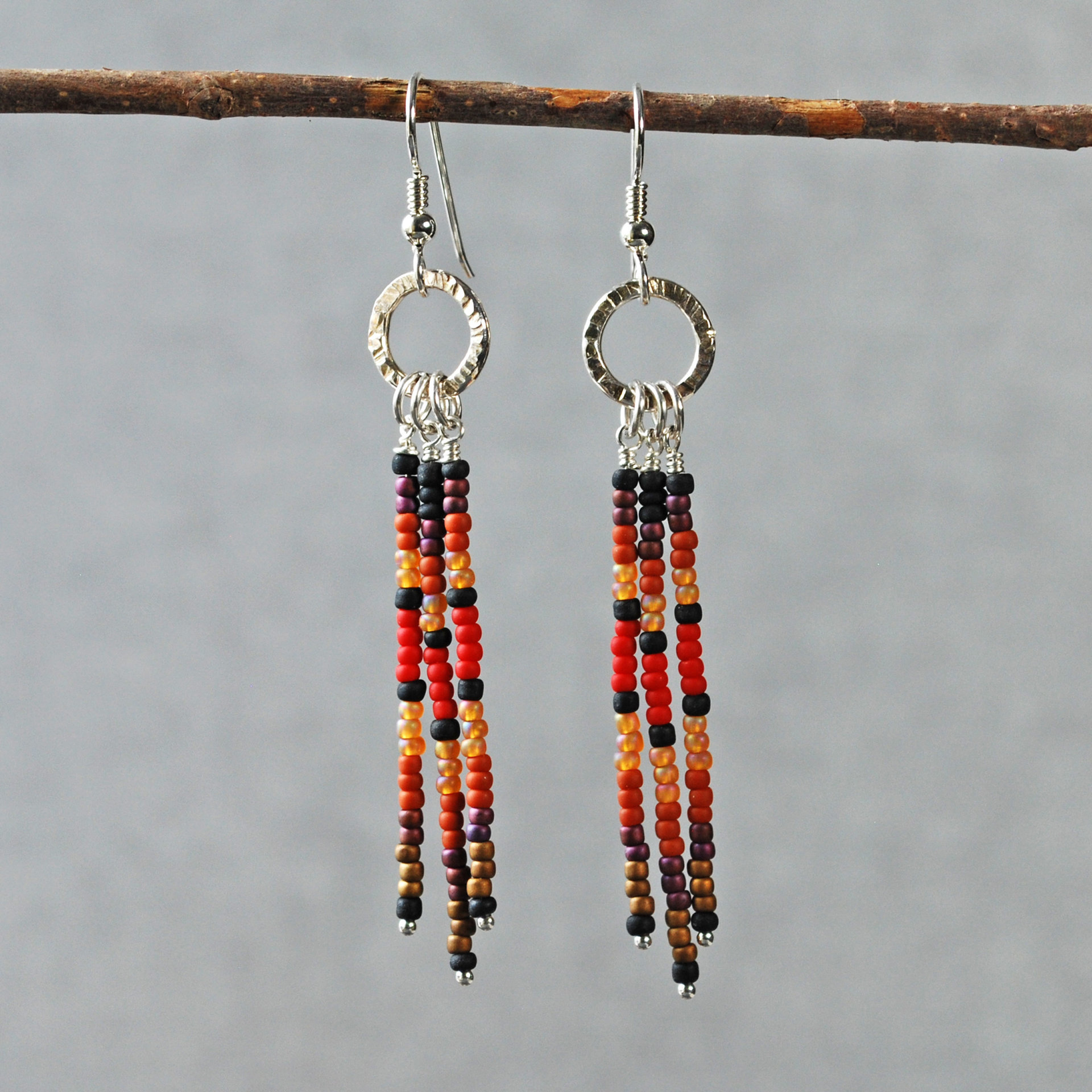 Silver earrings with red, brown, black dangles