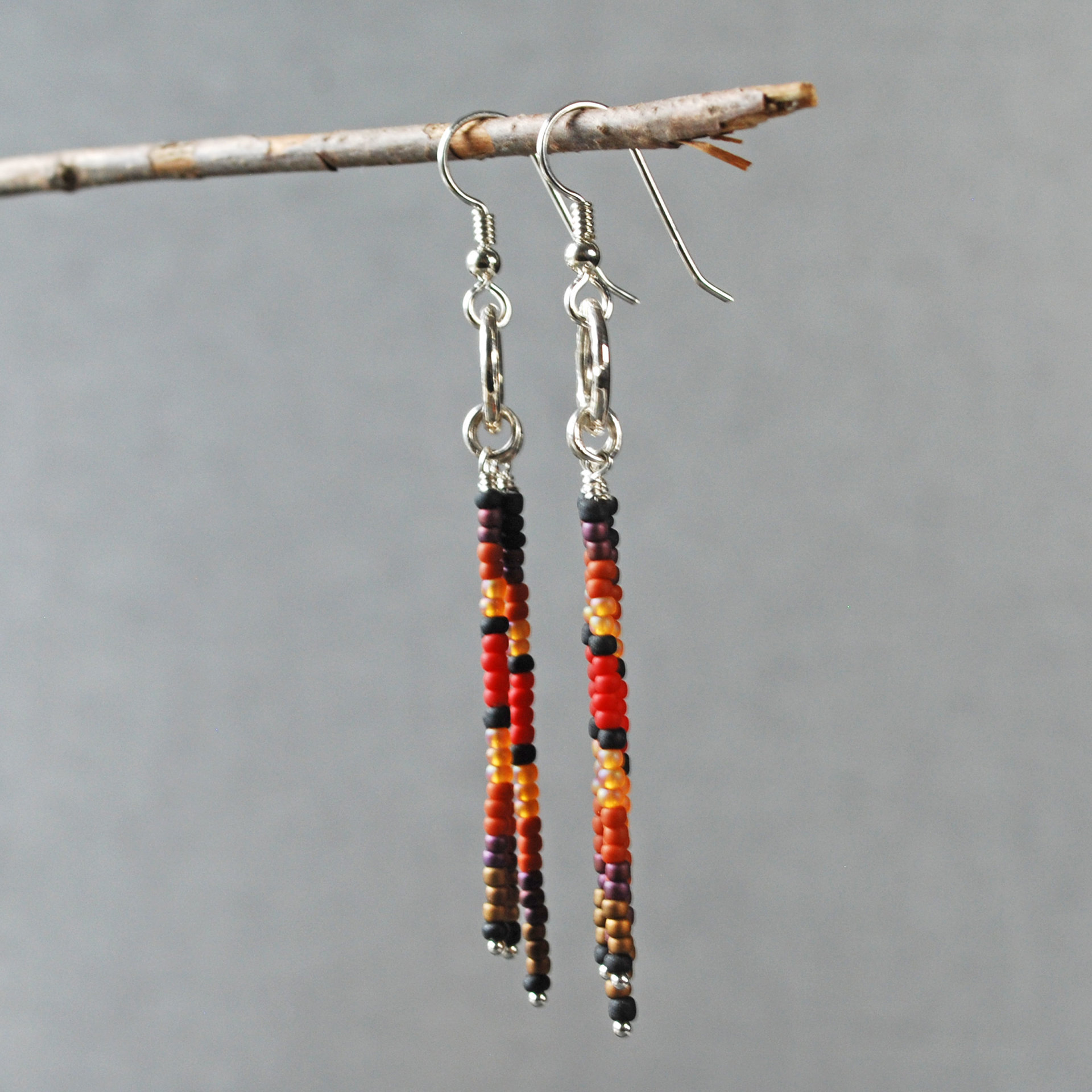 Silver earrings with red, brown, black dangles