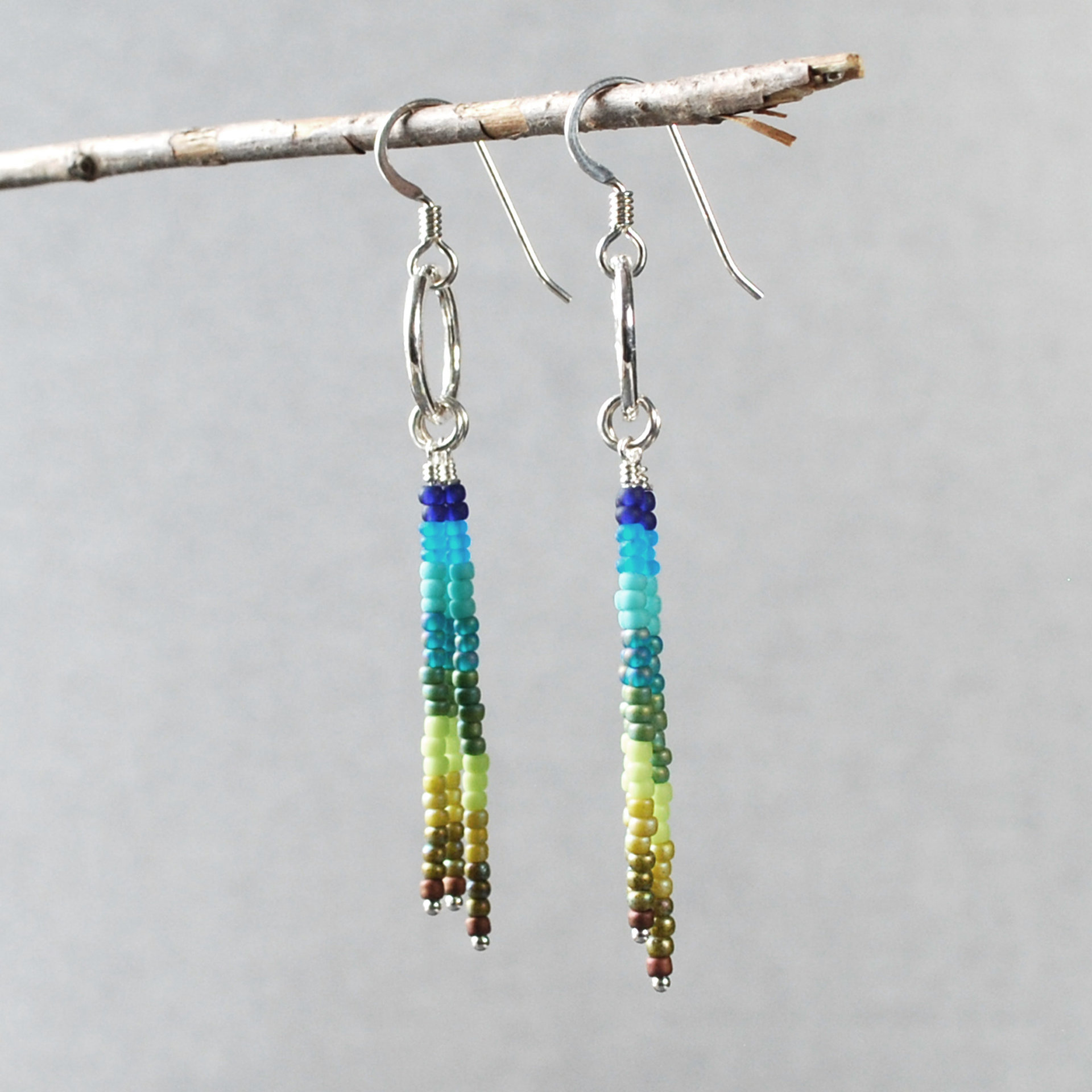 Silver earrings with blue and green dangles