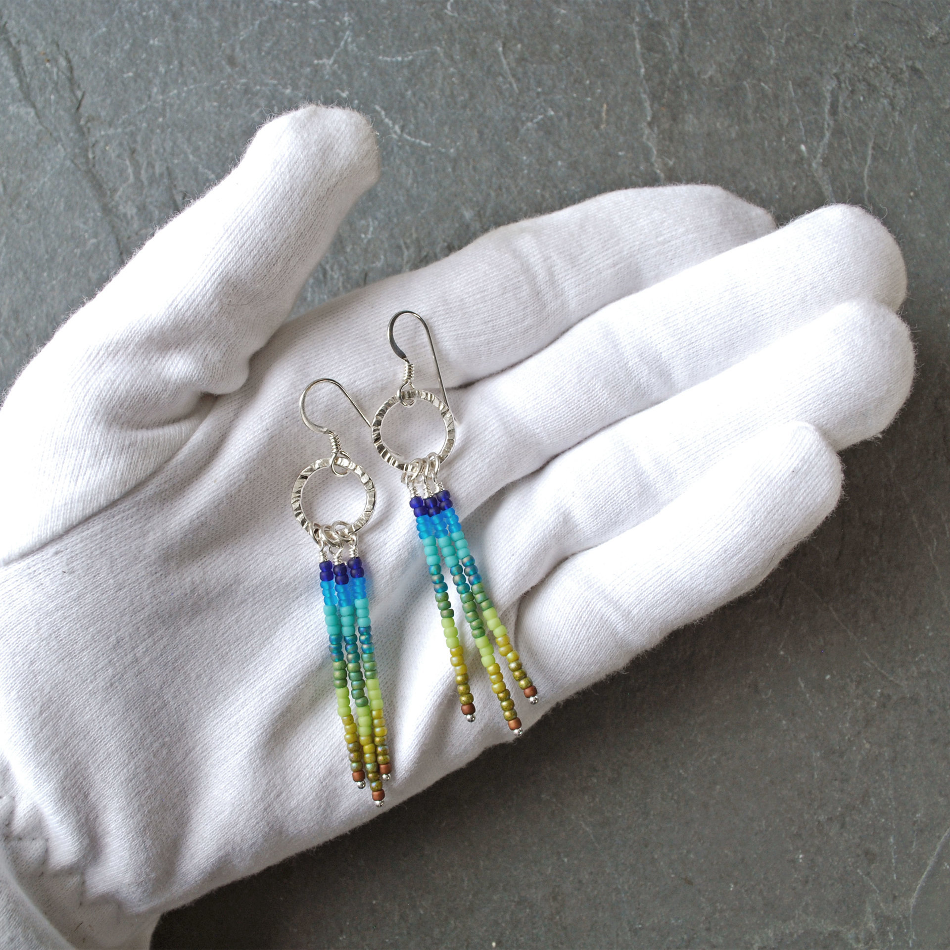 Silver earrings with blue and green dangles