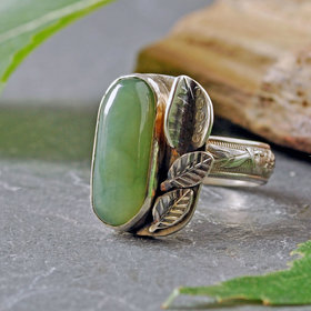 Nephrite Jade silver ring, with silver leaves beside stone on the top