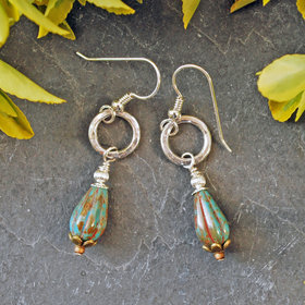 Earrings with hammered silver ring and melon shaped, teal Czech glass tear drop beads