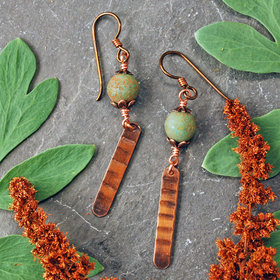Earrings with green matte Czech glass on top, textured copper dangle below